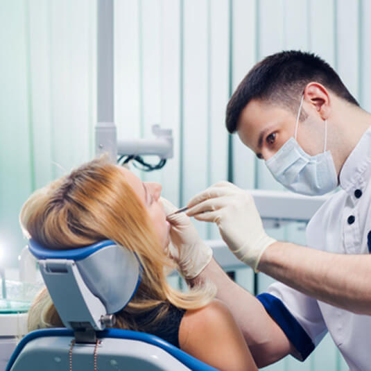 Dentist looking in woman’s mouth