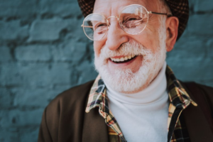 Man smiling and looking hip with his dental implants