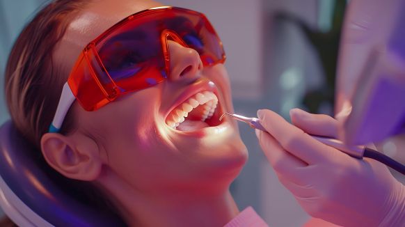 An AI image of a dentist using a soft tissue laser on a female patient.